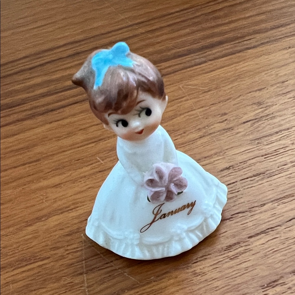 Charming Ceramic Figurine with Blue Accent